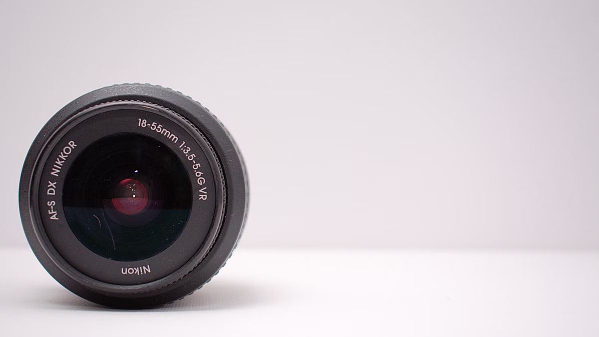 Detailed close-up shot of a Nikon AF-S DX NIKKOR lens on a white background.